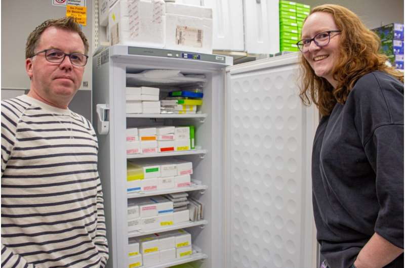 Warren Booth (at left) and Lindsay Miles at one of several refrigerators filled with samples of bed bugs collected from all over the world. Credit: Felicia Spencer for Virginia Tech. Bed bugs are most likely the first human pest, new research shows