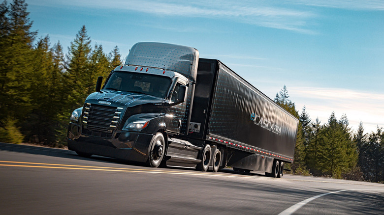 A Freightliner eCascadia driving down a rural highway