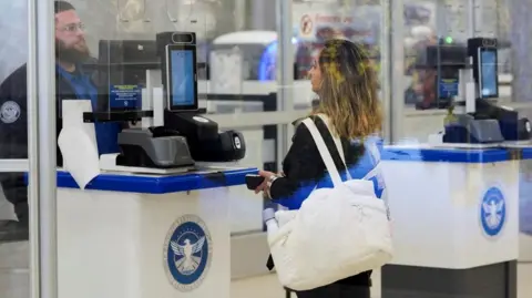 Reuters A person gets checked in by a TSA agent at a security counter at Hartsfield-Jackson Atlanta International Airport