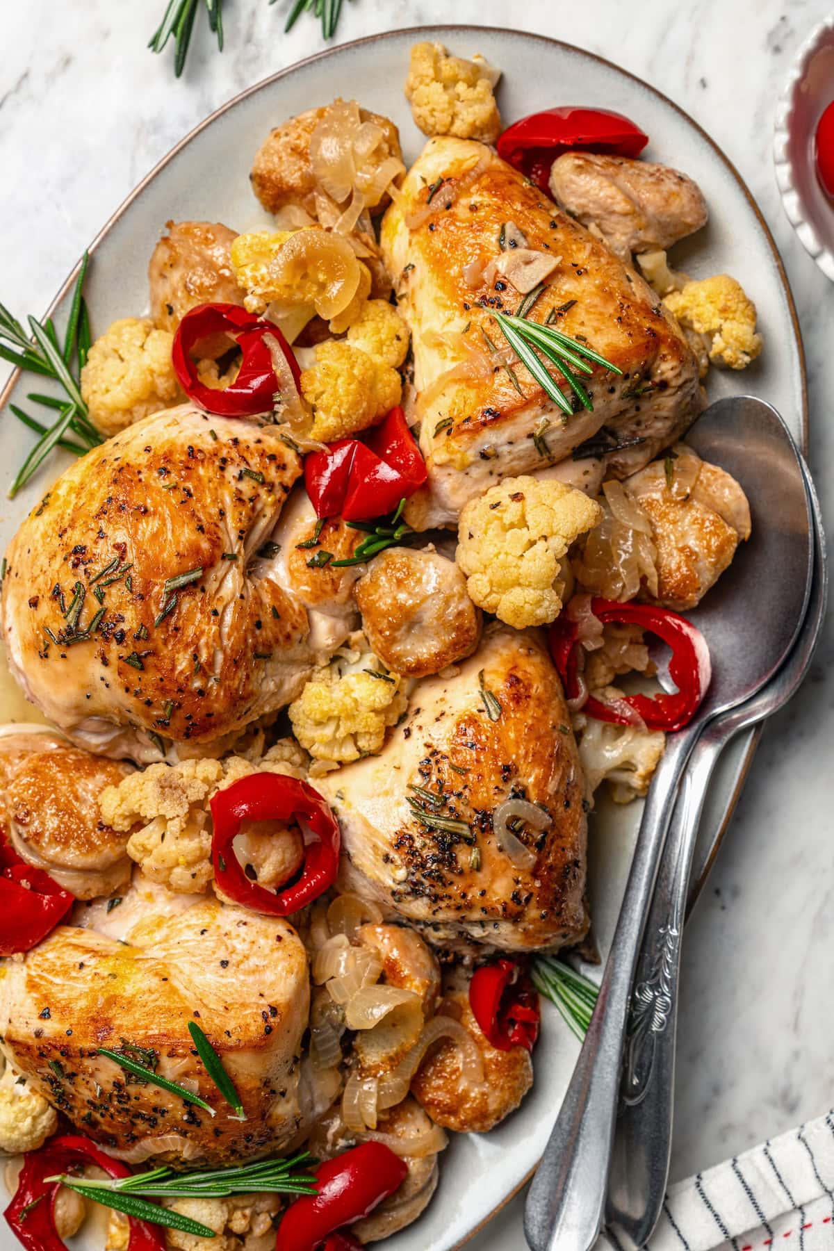 Cauliflower and chicken breasts make this Chicken Scarpariello recipe low carb, but it's just as spicy and flavorful as the classic version! Platter of chicken scarpariello with sausage, peppers, and cauliflower.