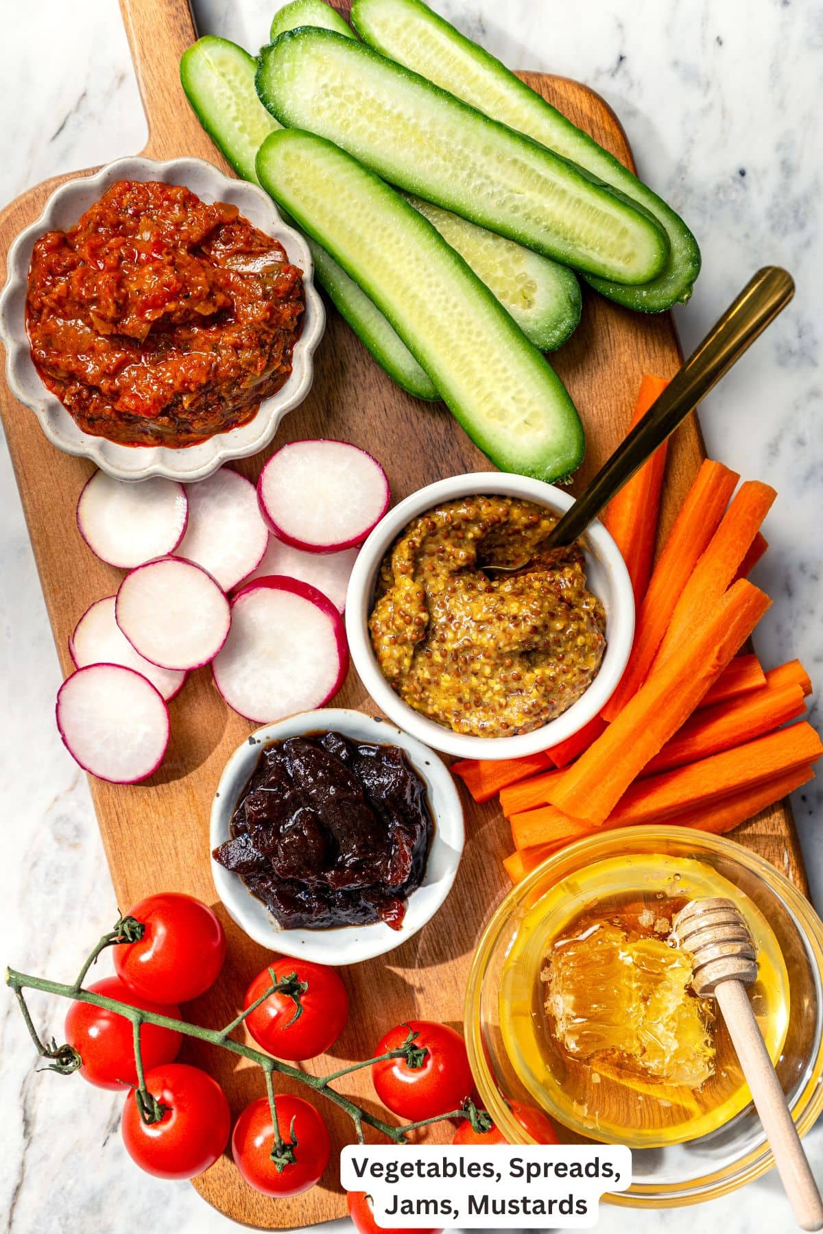 Vegetables, spreads, jams, and mustard for charcuterie board.